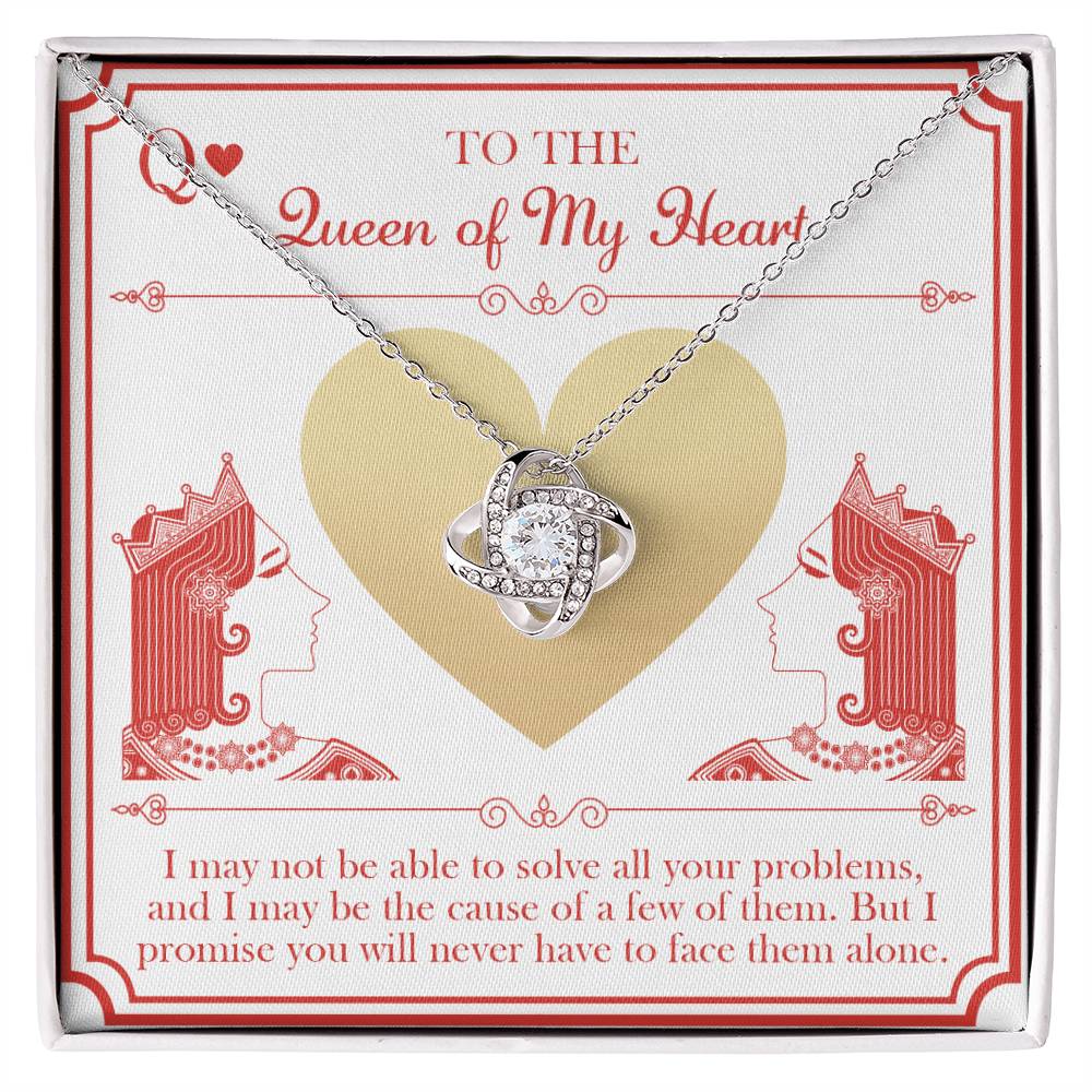 The "To Wife, The Queen - Love Knot Necklace," featuring cubic zirconia crystals, is beautifully presented on a card that displays a heart and two queens. The card bears the words "To the Queen of My Heart" along with a heartfelt message underneath.