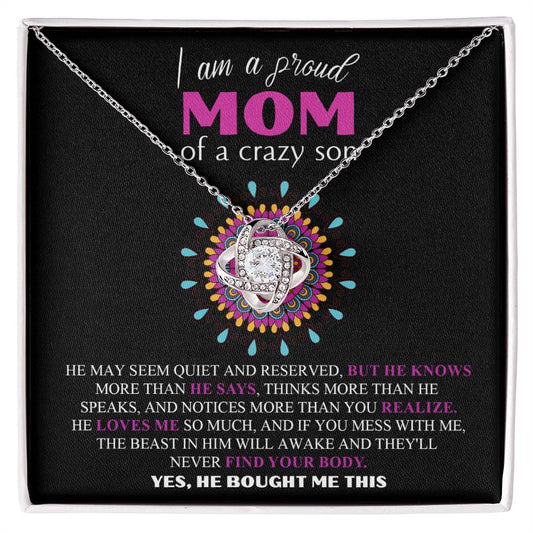 A "To Mom, Proud Mom" love knot necklace with a pendant inside a gift box, featuring an inscription celebrating a proud mom of a son, with a detailed description of the son's traits.