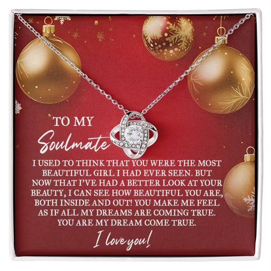 The Soulmate-Your Beauty - Love Knot Necklace features an intertwined pendant embellished with cubic zirconia crystals, beautifully presented on a red card with gold ornaments. The card includes a heartfelt message to your soulmate, conveying love and appreciation, making it an ideal gift for your special someone.