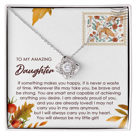 Introducing the "Daughter-Makes You Happy - Love Knot Necklace," featuring an intricate intertwined design, set on a card that reads "To My Amazing Daughter" and bears a heartfelt message about love and support. Crafted in 14k white gold and adorned with shimmering cubic zirconia crystals.
