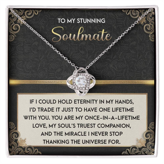 The Soulmate-Truest Companion - Love Knot Necklace features an intertwined design with sparkling cubic zirconia crystals, presented in a decorative box. It reads: "To my stunning soulmate," followed by a heartfelt message about eternal love and gratitude—a perfect personalized gift for your unique bond.