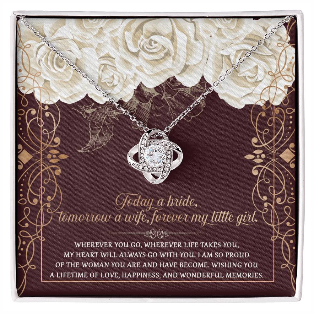 The "To Daughter, Wedding Wonderful Memories - Love Knot Necklace," featuring a white gold finish and embedded cubic zirconia gems, is displayed in a box with a floral background and an inscribed sentimental message for the bride.