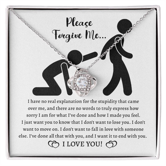 The Sorry-Made You Feel - Love Knot Necklace in 14k white gold and a card with the message "Please Forgive Me... I have no real explanation for the stupidity that came over me... I love you!" is shown. The necklace features intertwined hearts adorned with cubic zirconia crystals.