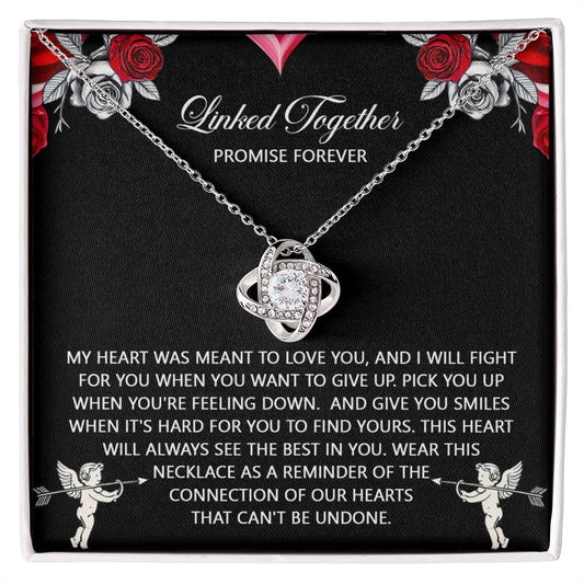 The "Soulmate-To Find Yours - Love Knot Necklace" features intertwined cubic zirconia crystals. It comes in a gift box with decorative text and cupid illustrations, making it an ideal personalized gift.