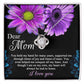 The "To Mom, Held My Hand - Love Knot Necklace" features a stunning cubic design adorned with cubic zirconia crystals. It is beautifully presented in a box with a heartfelt message surrounded by purple flowers, expressing gratitude and love to a mother and ending with "I love you." This personalized gift is perfect for showing your appreciation.