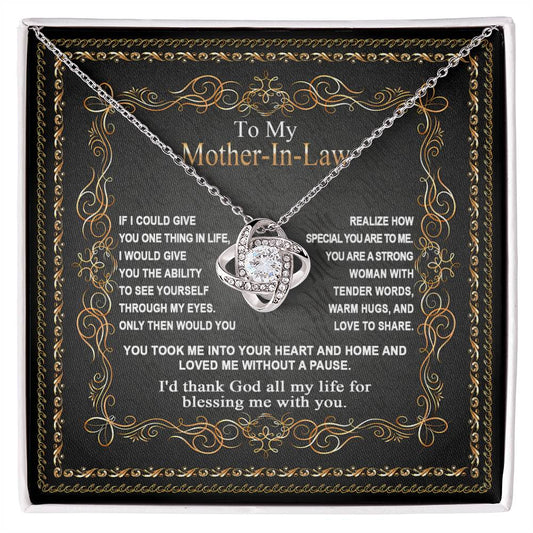 Black jewelry box displaying the "To Mother-In-Law, Through My Eyes - Love Knot Necklace" with a heart-shaped pendant, surrounded by a heartfelt message on the box's lid.
