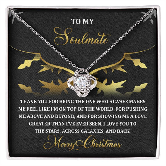 The Soulmate-A Love - Love Knot Necklace, featuring a heart-shaped pendant adorned with cubic zirconia crystals, sparkles in its box alongside a heartfelt Christmas message for your soulmate.