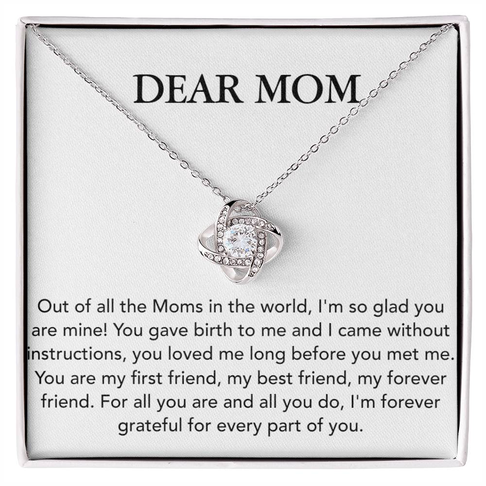 A "Dear Mom, Out of All The Moms In The World - Love Knot Necklace" by ShineOn Fulfillment with a heart-shaped design is displayed in a box with a sentimental message titled "dear mom", expressing gratitude and love for mothers.