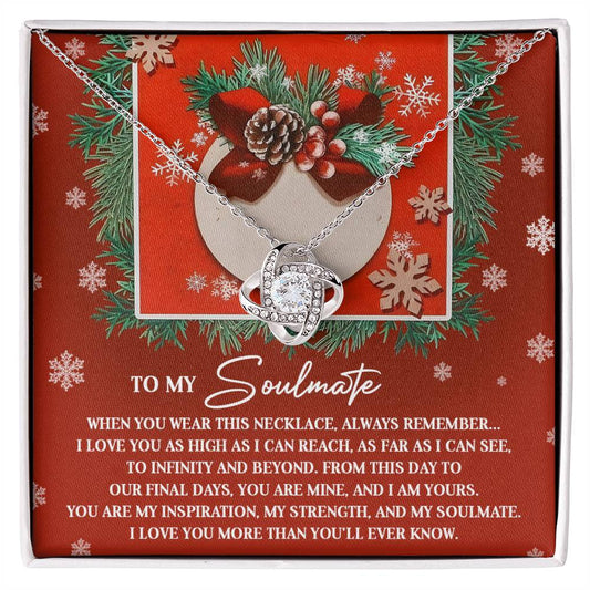 The Soulmate-I Am Yours - Love Knot Necklace, showcasing an intertwined knot design, is presented on a festive card. It is adorned with shimmering cubic zirconia crystals and features a heartfelt message about love and soulmates.