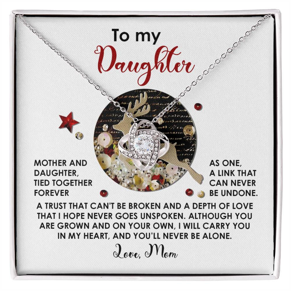 The Daughter-Forever As One - Love Knot Necklace, featuring intertwined rings adorned with cubic zirconia crystals, comes on a card with a heartfelt message from a mother to her daughter. This unique gift beautifully symbolizes the unbreakable bond and enduring love between mother and child.