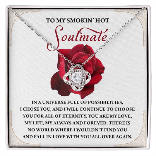 The Soulmate-Over Again Love Knot Necklace is showcased on a jewelry box with a red rose design and romantic message, enhanced by shimmering Cubic Zirconia Crystals.