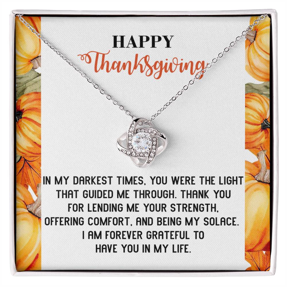 The Thanksgiving-Guided Me Through - Love Knot Necklace, featuring a heart-shaped pendant adorned with sparkling cubic zirconia crystals, rests gracefully on a Thanksgiving-themed card, beautifully capturing the timeless gratitude of an unbreakable bond.