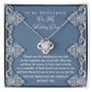 To Bridesmaid, By My Side - Love Knot Necklace with interlocking heart design, adorned with sparkling cubic zirconia crystals, displayed in a box with a heartfelt message for the bridesmaid. The message expresses gratitude for her unwavering support on the wedding day.