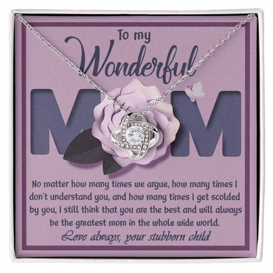 A To Mom, The Greatest Mom - Love Knot Necklace with a pendant displayed on a card with a heartfelt message to "mom" from a "stubborn child," expressing love and admiration.