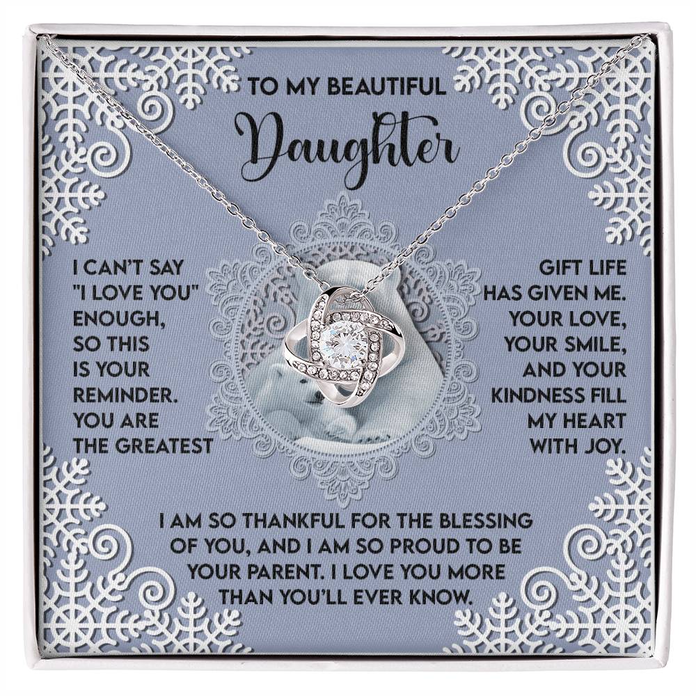 The Daughter-Fill My Heart - Love Knot Necklace, embellished with dazzling cubic zirconia, is beautifully presented in a gift box that includes touching messages for a daughter and is framed by intricate snowflake designs—making it a wonderfully personalized gift.