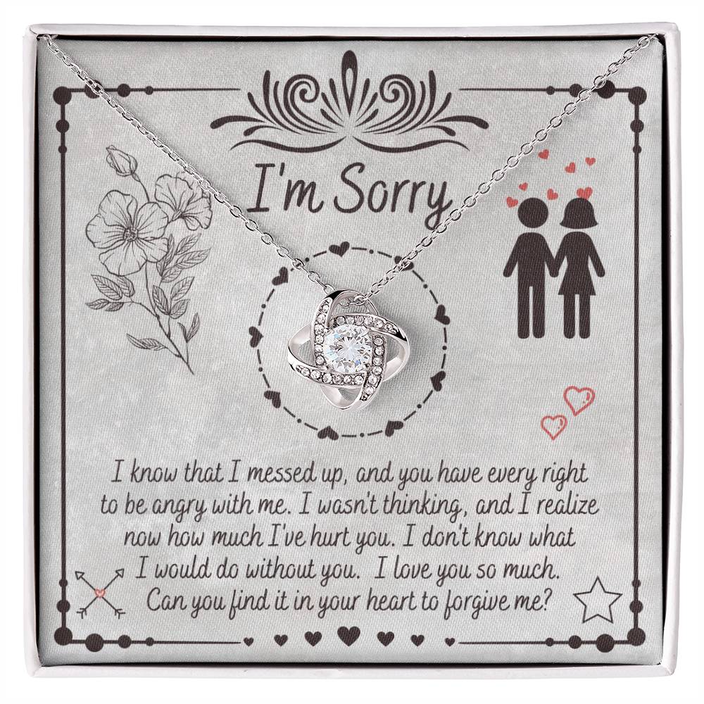 The "Sorry-I Would Do - Love Knot Necklace" is a personalized gift box that includes an apology message and a Love Knot Necklace adorned with cubic zirconia crystals. The box features the phrase "I'm Sorry" above illustrations of flowers and a couple, expressing regret for a mistake and seeking forgiveness.