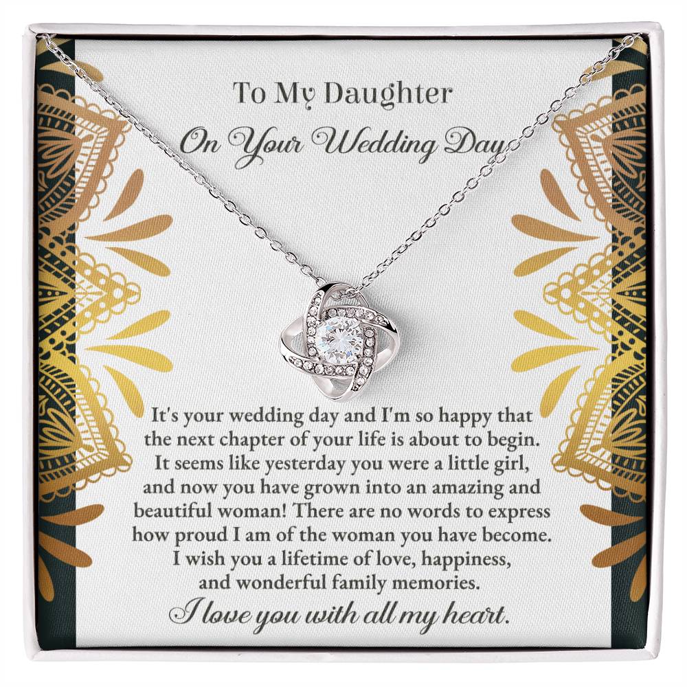 The "To Daughter, Wedding - A Little Girl - Love Knot Necklace" adorned with cubic zirconia crystals is elegantly showcased in a box containing a heartfelt message for a daughter on her wedding day. The text conveys love, pride, and best wishes for a joyful marriage, beautifully accentuated by the option of a white gold or yellow gold finish.