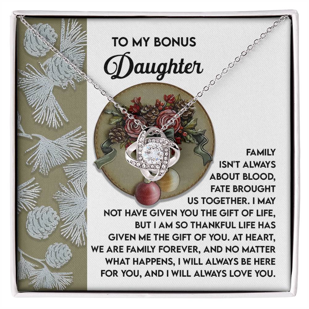 The Bonus Daughter-Gift Of You - Love Knot Necklace, featuring interlocking rings, is showcased in a gift box. The accompanying message reads: "To my bonus daughter, family isn’t always about blood... always be here for you, and I will always love you." This personalized gift beautifully represents enduring connection and affection.