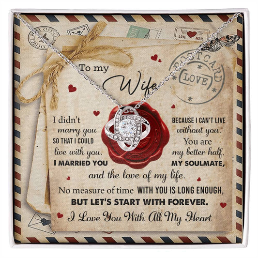 A "To Wife, Marry You - Love Knot Necklace" with an interlocking rings pendant, adorned with cubic zirconia crystals, displayed in a box featuring the background design of a love letter. The letter includes heartfelt messages for a wife, expressing love and commitment—a perfect personalized gift.