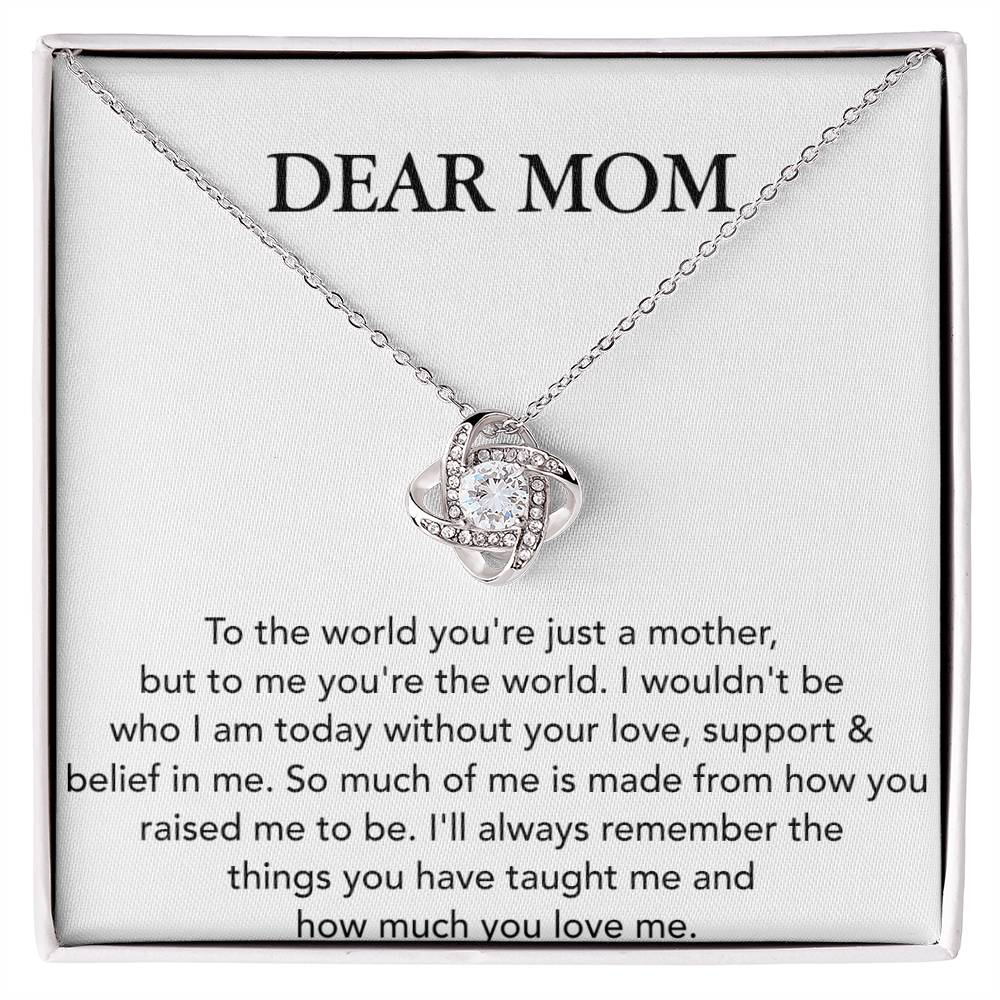 Dear Mom, To The World You're Just A Mother - Love Knot Necklace with a heart-shaped pendant adorned with cubic zirconia crystals, displayed on a card with a sentimental message by ShineOn Fulfillment.