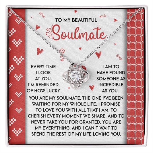 The Soulmate-My Whole Life Love Knot Necklace, embellished with cubic zirconia and an intertwined heart design, comes in a box inscribed with "To My Beautiful Soulmate" and includes a touching message about love and commitment—ideal as a cherished personalized gift.