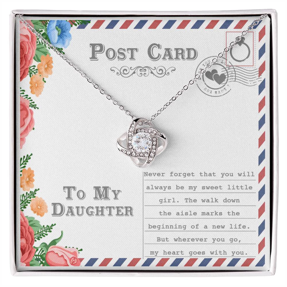 The "To Daughter, Goes With You - Love Knot Necklace," featuring an intertwining design with a gold finish and adorned with cubic zirconia crystals, is displayed on a postcard that reads "To My Daughter." The message includes a heartfelt note about your daughter's wedding and a mother's enduring love.