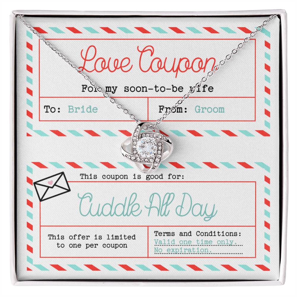 The "To Wife, Wedding-Love Coupon - Love Knot Necklace" adorned with cubic zirconia crystals sits atop a decorated card labeled "Love Coupon." The card, addressed to "Bride" from "Groom," offers a "Cuddle All Day" coupon with no expiration date—a perfect gift for a loved one.