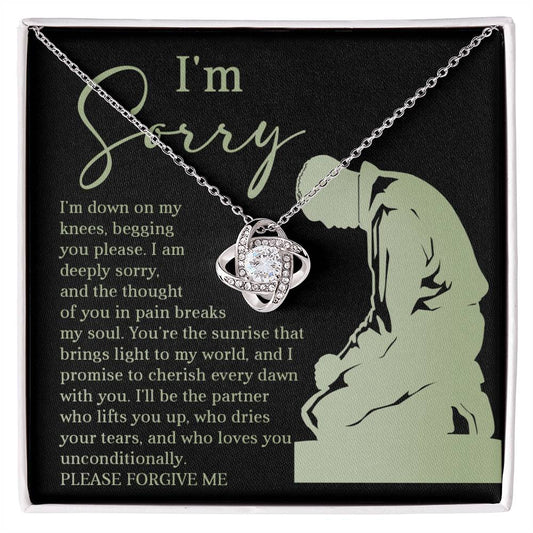 Box containing the "Sorry-On My Knees - Love Knot Necklace," adorned with cubic zirconia crystals and featuring a heartfelt message that reads, "I'm sorry. I'm down on my knees, begging you please. I am deeply sorry. Please forgive me.