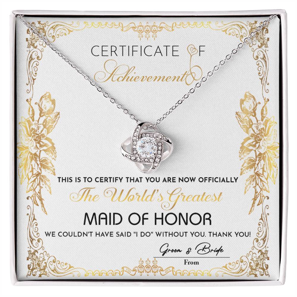 Presenting the "To Maid Of Honor, Certificate Of Achievement - Love Knot Necklace," designed to honor the world's greatest maid of honor. This exquisite necklace, offered in a choice of white gold or yellow gold finish and adorned with shimmering cubic zirconia, represents the heartfelt gratitude of the bride and groom for their invaluable role in the wedding.