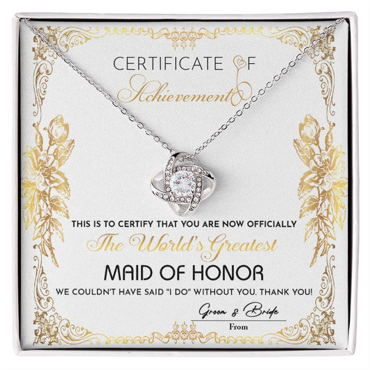 Presenting the "To Maid Of Honor, Certificate Of Achievement - Love Knot Necklace," designed to honor the world's greatest maid of honor. This exquisite necklace, offered in a choice of white gold or yellow gold finish and adorned with shimmering cubic zirconia, represents the heartfelt gratitude of the bride and groom for their invaluable role in the wedding.