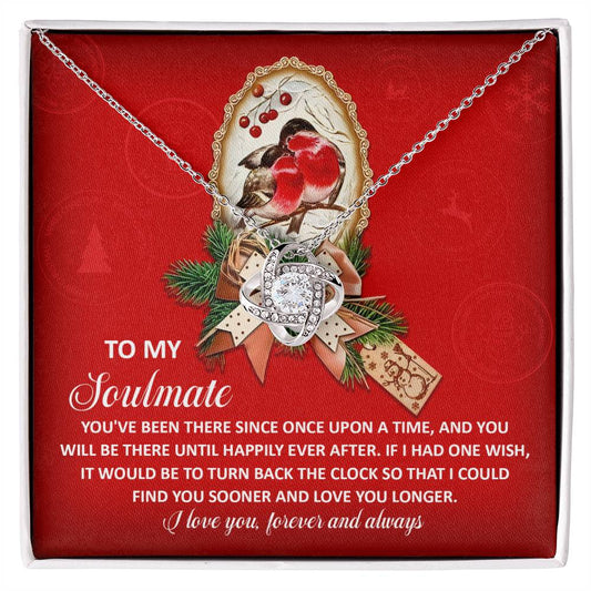 The Soulmate-Once Upon - Love Knot Necklace, showcasing a silver intertwined ring pendant adorned with cubic zirconia crystals, is elegantly set against a red backdrop with a bird illustration and a heartfelt message about eternal love—making it an ideal personalized gift.