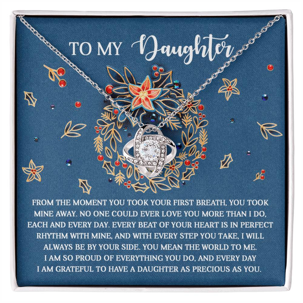 The Daughter-Perfect Rhythm - Love Knot Necklace, featuring a silver heart-shaped pendant with an infinity symbol and adorned with sparkling cubic zirconia crystals, is beautifully displayed on a blue background surrounded by floral elements. Accompanied by a heartfelt message, it creates the perfect personalized keepsake for someone special.