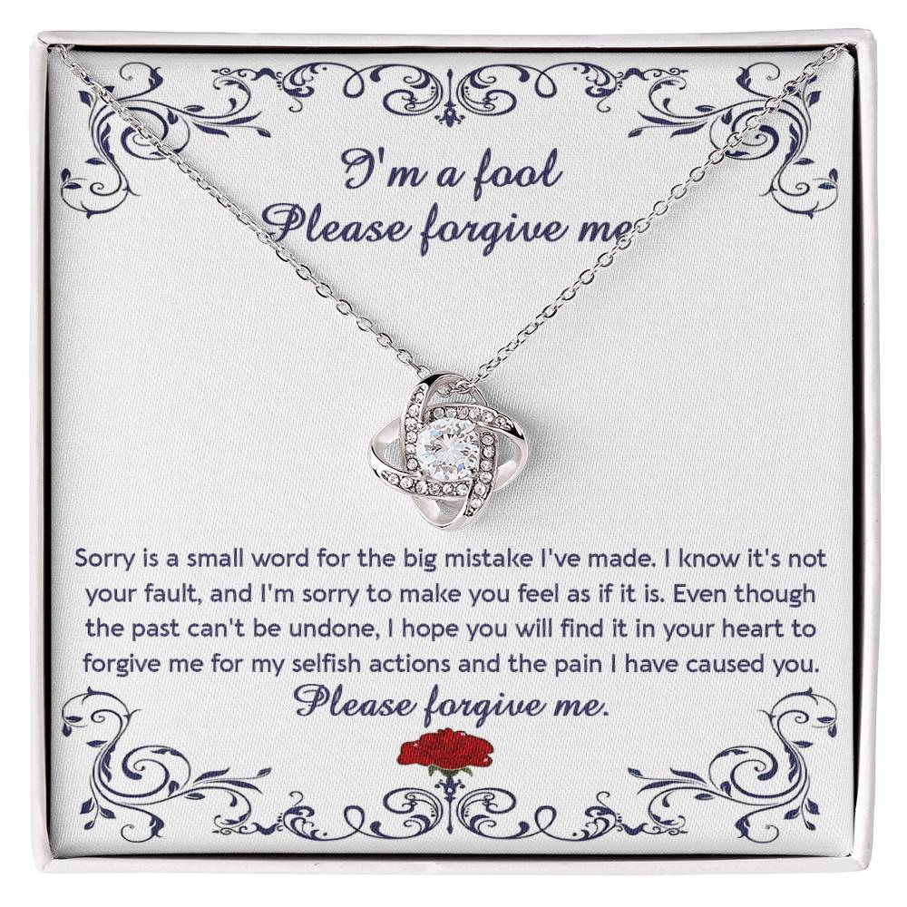 The "Sorry, I_m A Fool - Love Knot Necklace" features a 14k white gold pendant encased in a box with a heartfelt apology message. This message conveys regret and seeks forgiveness for causing pain and acting selfishly. The pendant is adorned with premium cubic zirconia crystals, adding an extra touch of elegance.