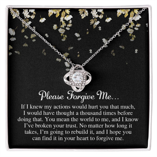 The Sorry-Broken Your Trust - Love Knot Necklace, featuring interlocking rings adorned with cubic zirconia crystals, is set against a black background with delicate floral designs. The accompanying text pleads for forgiveness and expresses deep remorse.