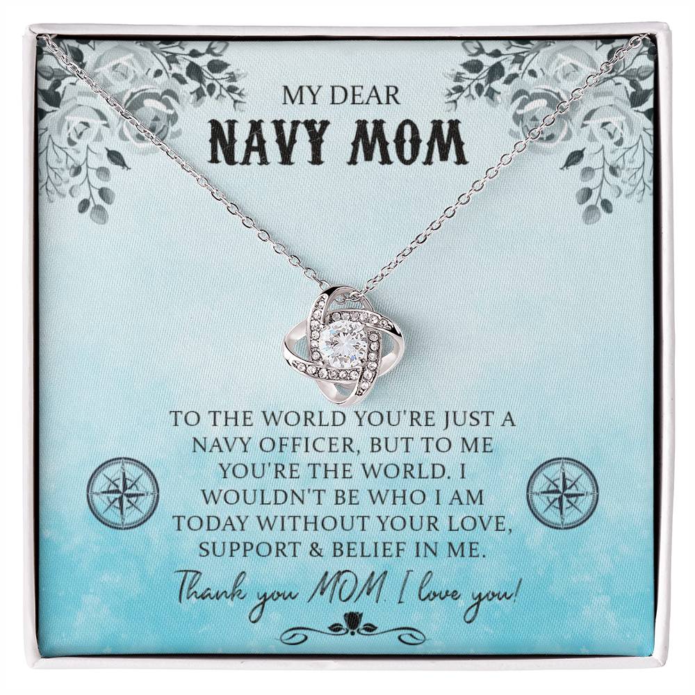 A My Dear Navy Mom, To The World You're Just A Navy Officer - Love Knot Necklace is displayed on a blue background with a floral pattern, accompanied by a heartfelt, personalized message addressed to a "navy mom," expressing personal gratitude and appreciation.  Brand Name: ShineOn Fulfillment