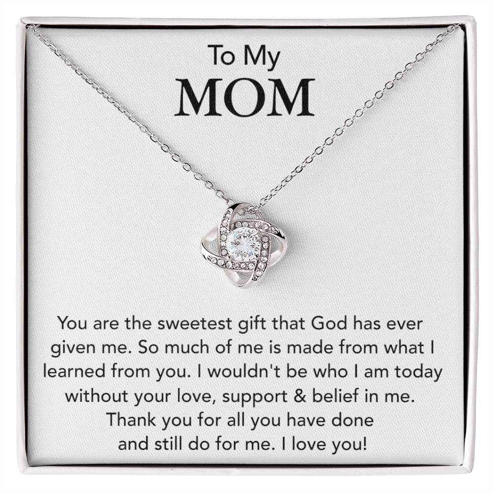 A ShineOn Fulfillment To My Mom, You Are The Sweetest Gift That God Has Ever Given Me - Love Knot Necklace with a heart-shaped pendant, featuring cubic zirconia crystals that express love and gratitude to a mother, presented in a gift box.
