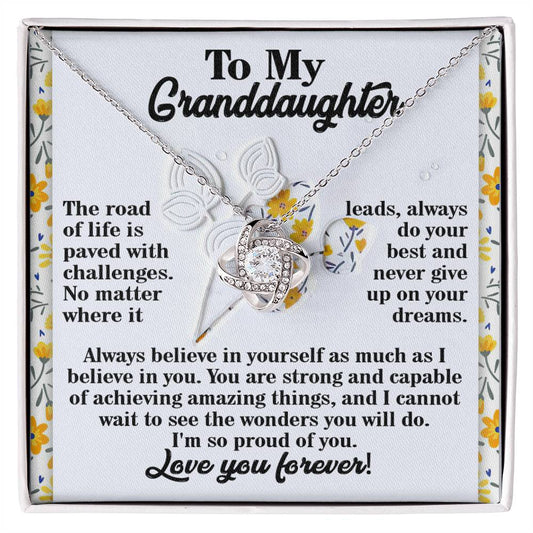 The "Granddaughter-On Your Dreams - Love Knot Necklace," embellished with radiant cubic zirconia crystals, is elegantly presented on a decorative card. This thoughtful personalized gift conveys an inspirational message, encouraging your granddaughter to embrace strength and self-belief as she faces life's challenges.