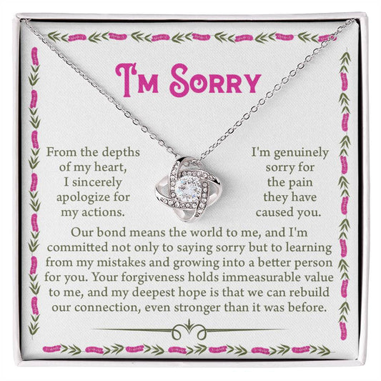 The Sorry-A Better Person - Love Knot Necklace features an intertwined heart pendant adorned with premium cubic zirconia crystals, presented on a card with an apologetic message expressing deep remorse and a desire for forgiveness and improved connection.