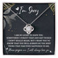 A Sorry-The Best Thing - Love Knot Necklace in a gift box featuring a note that reads "I'm Sorry," embellished with cubic zirconia crystals and accompanied by a heartfelt apology message expressing love and regret for misspoken words.