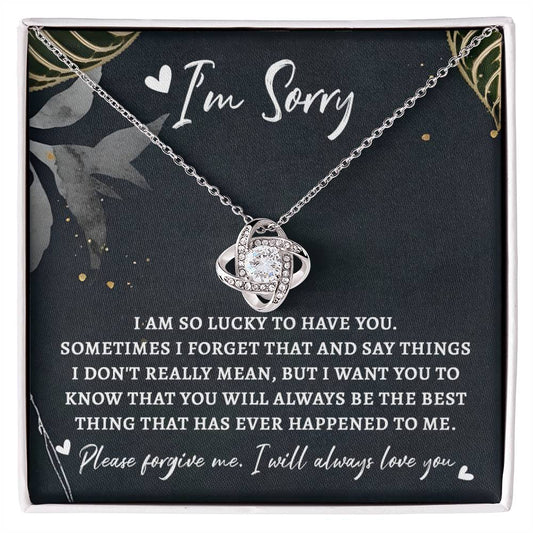 A Sorry-The Best Thing - Love Knot Necklace in a gift box featuring a note that reads "I'm Sorry," embellished with cubic zirconia crystals and accompanied by a heartfelt apology message expressing love and regret for misspoken words.