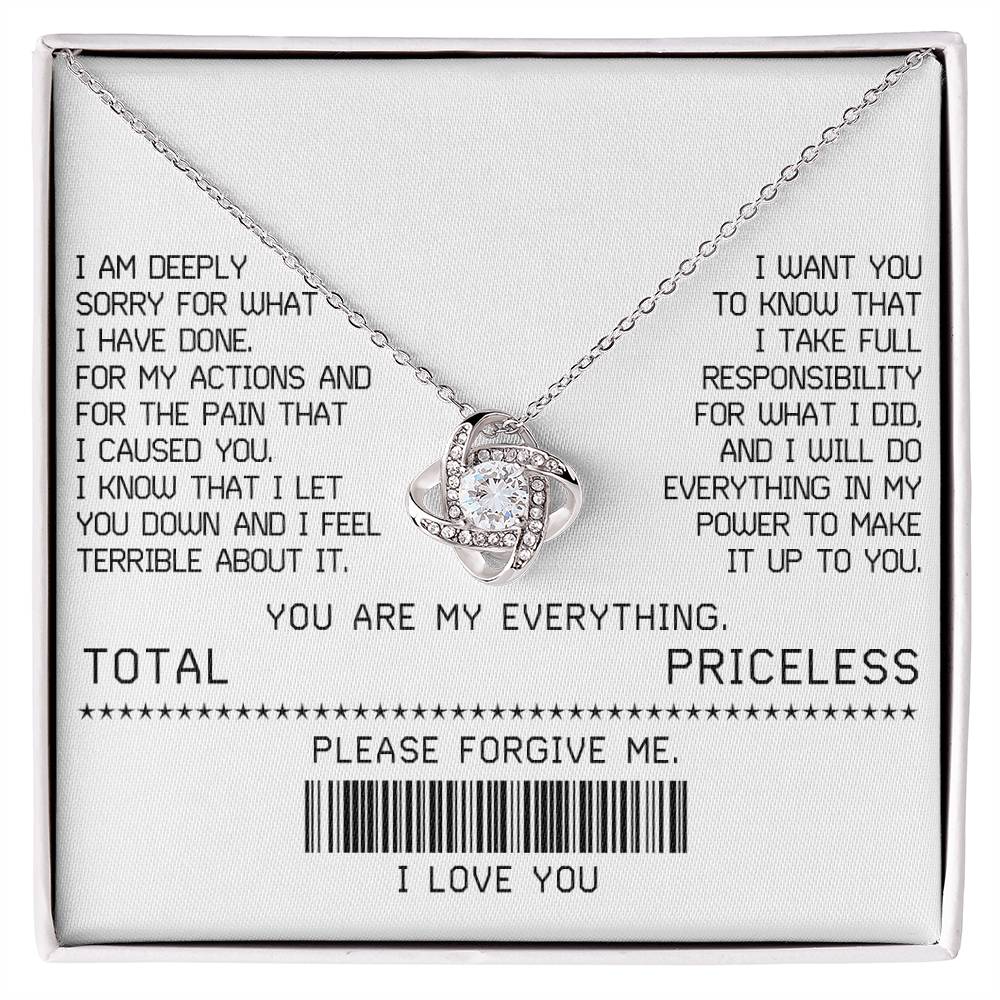 The Sorry-Make It Up - Love Knot Necklace, featuring a white gold finish and adorned with shimmering cubic zirconia crystals, is beautifully presented on a card with an apology message. This card includes phrases such as "TOTAL PRICELESS," "PLEASE FORGIVE ME," and "I LOVE YOU," along with a barcode, making it the perfect elegant touch for your sincere apology.