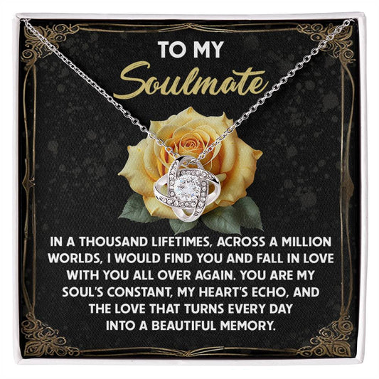 The Soulmate-Beautiful Memory Love Knot Necklace features a gold finish and intertwined design, showcased on a card with roses and loving text for a soulmate. It sparkles with cubic zirconia stones.