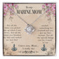 A To My Marine Mom, For All The Times You Picked Me Up - Love Knot Necklace necklace with a cubic zirconia crystals heart and anchor design is displayed on a card with a sentimental message addressed to a "marine mom," expressing appreciation and love for her nurturing and selflessness by ShineOn Fulfillment.