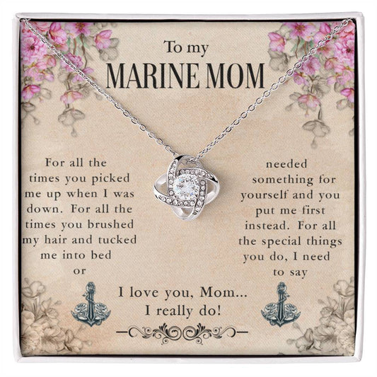 A To My Marine Mom, For All The Times You Picked Me Up - Love Knot Necklace necklace with a cubic zirconia crystals heart and anchor design is displayed on a card with a sentimental message addressed to a "marine mom," expressing appreciation and love for her nurturing and selflessness by ShineOn Fulfillment.