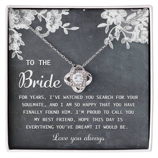 The "To Bride, My Best Friend - Love Knot Necklace" in silver, adorned with cubic zirconia crystals, is presented on a card with a sentimental message for the bride and comes in a decorated gift box.