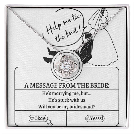 A To My Bridesmaid, Stuck With Us - Love Knot Necklace rests on a card that reads, "Help me tie the knot! A message from the bride: He's marrying me, but... He's stuck with us. Will you be my bridesmaid?