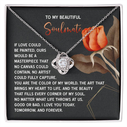 The Soulmate-A Masterpiece - Love Knot Necklace showcases an intertwined design with cubic zirconia crystals. It includes a card featuring a poetic message and orange rose illustration, making it an ideal personalized gift to cherish.