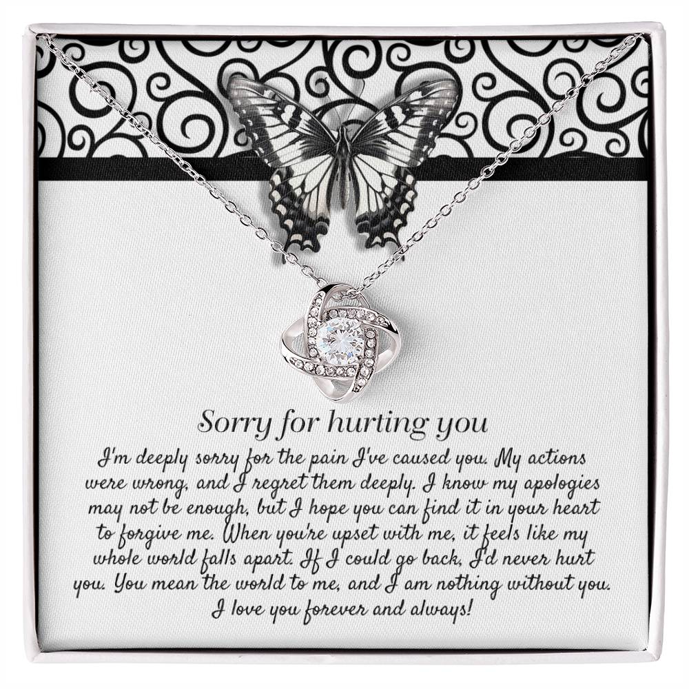 The "Sorry-Nothing Without You - Love Knot Necklace" features a heart-shaped pendant adorned with cubic zirconia crystals and is presented on a card with an apology message and a butterfly design.