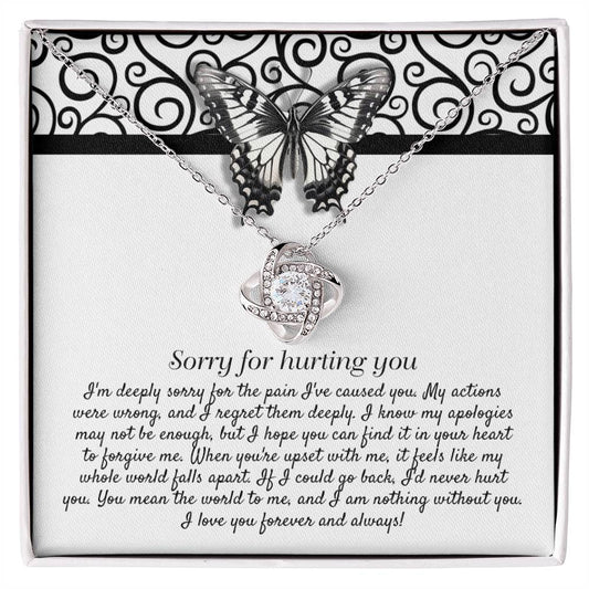 The "Sorry-Nothing Without You - Love Knot Necklace" features a heart-shaped pendant adorned with cubic zirconia crystals and is presented on a card with an apology message and a butterfly design.