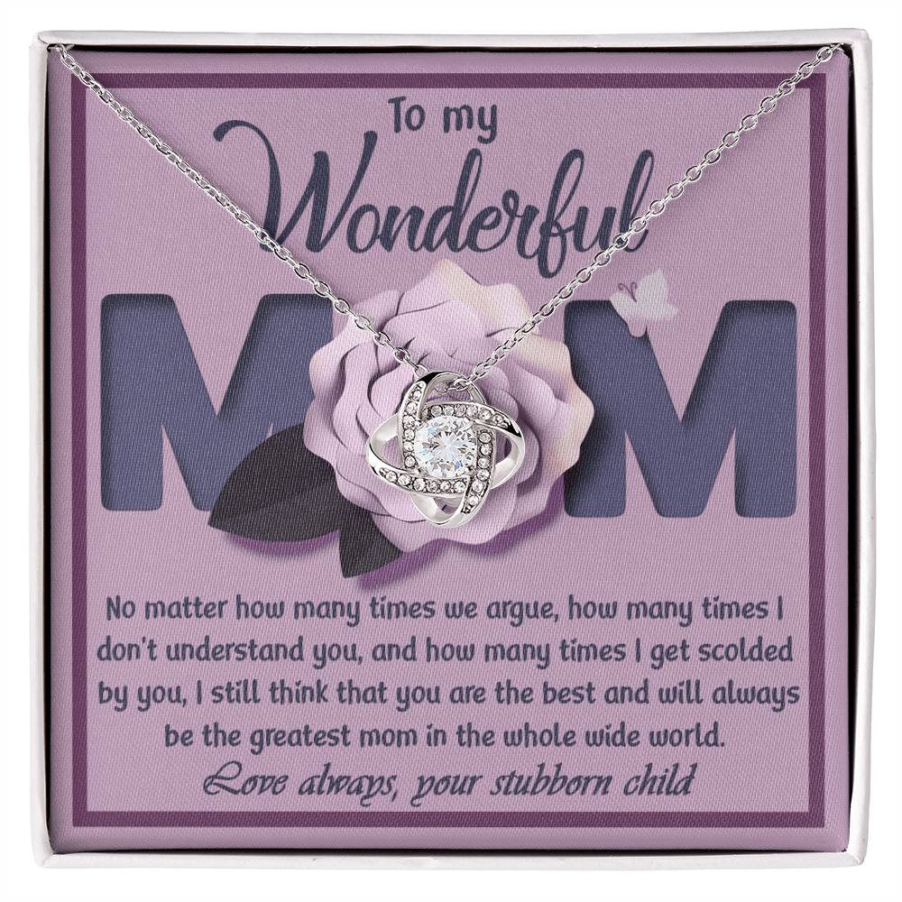 The "To Mom, The Greatest Mom - Love Knot Necklace," adorned with cubic zirconia crystals, is displayed in a box that reads, "To my Wonderful Mom". The box also includes a heartfelt message from a child to their mother, making it the perfect personalized gift.